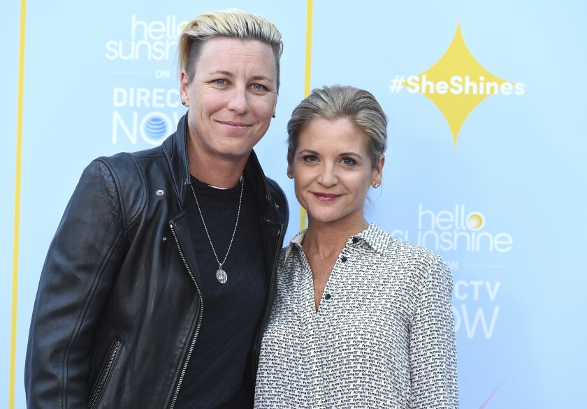 FILE - Abby Wambach, left, and Glennon Doyle appear at the Hello Sunshine Video on Demand channel launch in Los Angeles on Aug. 6, 2018. Doyle is the author of the best-selling memoirs, including, “Untamed.” (Photo by Jordan Strauss/Invision/AP, File)