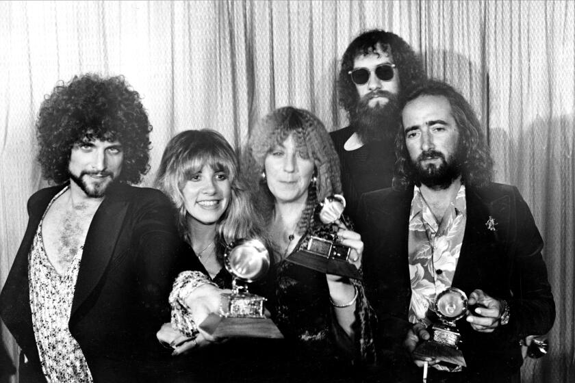 Members of Fleetwood Mac, from left, Lindsey Buckingham, Stevie Nicks, Christine McVie, Mick Fleetwood, wearing sunglasses, and John McVie, pose with their Grammys at the annual Grammy Awards in Los Angeles, Ca., Feb. 23, 1978. The group won in the category of Album of the Year for "Rumours." (AP Photo)