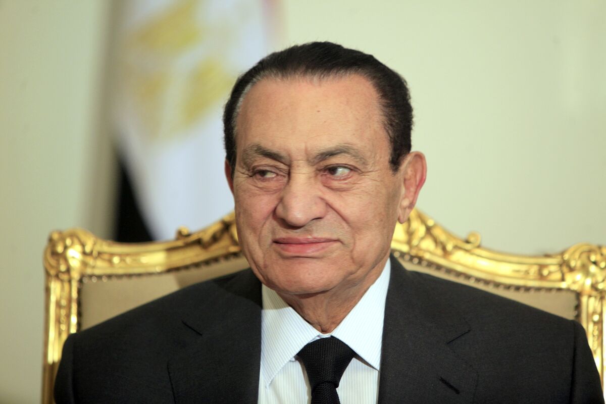 FILE - Egyptian President Hosni Mubarak attends a meeting with Emirates foreign minister at the Presidential palace in Cairo, Egypt, Tuesday, Feb. 8, 2011. Swiss prosecutors are concluding without any charges a decade-long investigation into alleged money laundering and organized crime linked to late former President Hosni Mubarak’s circles in Egypt, and will release some 400 million Swiss francs ($430 million) frozen in Swiss banks. The office of the Swiss attorney general said Wednesday, April 13, 2022, that information received as part of cooperation with Egyptian authorities wasn’t sufficient to back up the claims that emerged in the wake of Arab Spring uprisings in 2011 that felled Mubarak’s three-decade rule. (AP Photo/Amr Nabil, File)