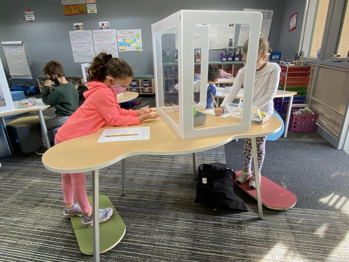 DMUSD students balance on Norvaboards while at work in the classroom.