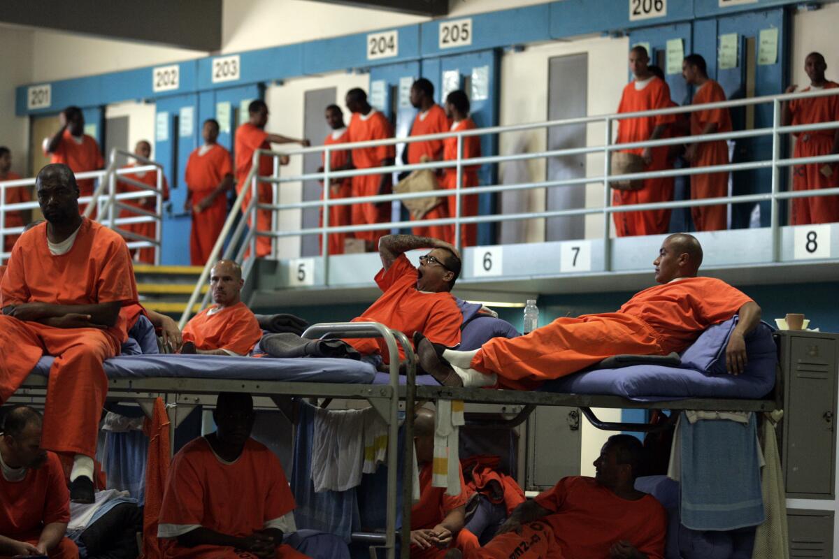 Inmates congregate at California State Prison in Lancaster in 2010. Gov. Jerry Brown wants to take control of California's prisons back from federal courts, but the official appointed to oversee inmate healthcare said the state is not ready.
