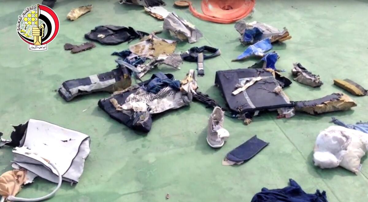 Egyptian officials display personal belongings and other wreckage from EgyptAir Flight 804.