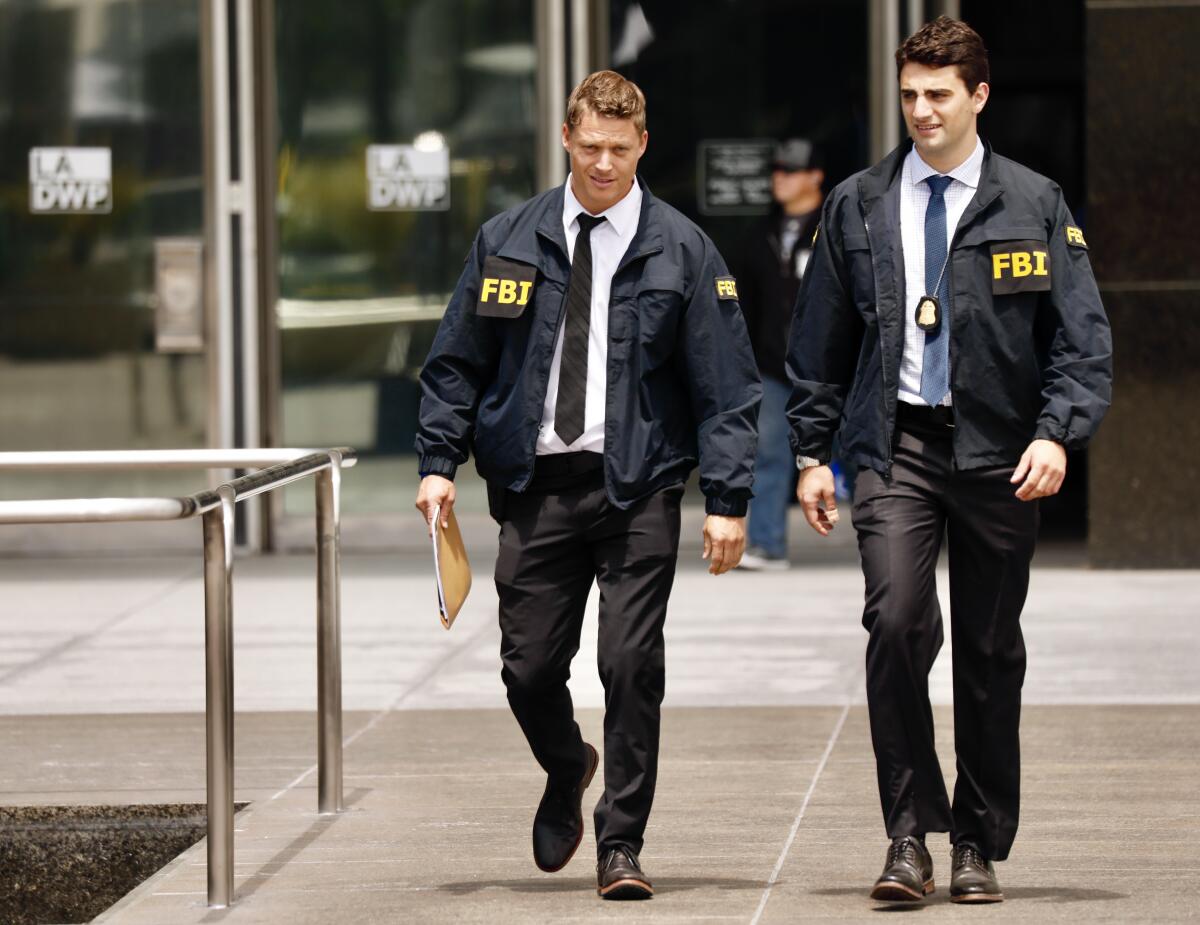 FBI agents leave the downtown headquarters of the Los Angeles Department of Water and Power in 2019.