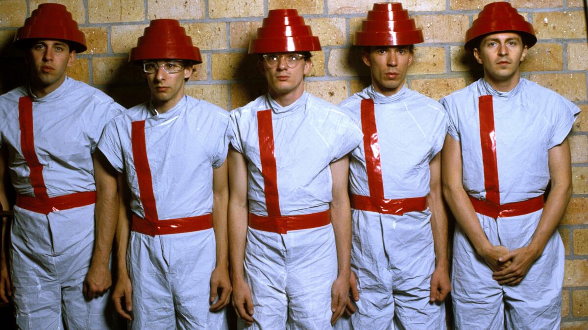 Five men in red and white futuristic uniforms
