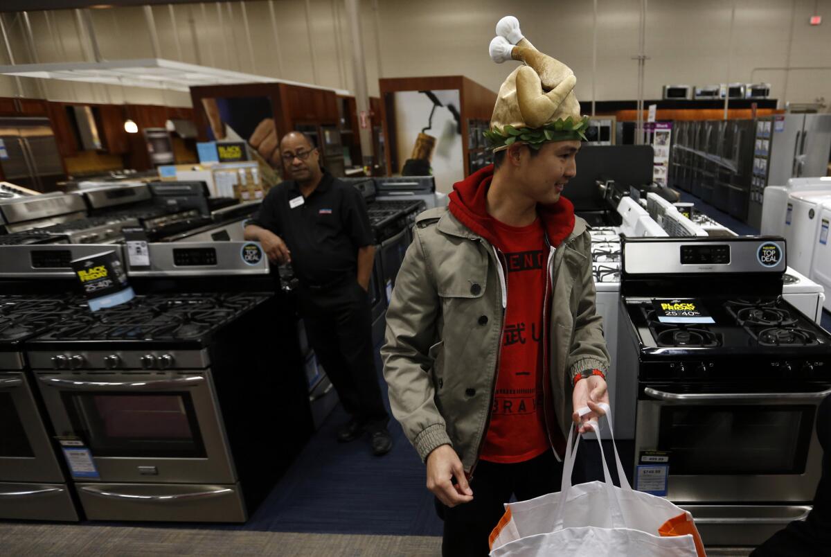 Wearing a turkey hat, Bryan Sato shops at a Best Buy in Los Angeles on Thanksgiving 2015.