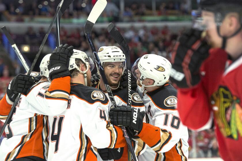 Ducks defenseman Simon Despres is surrounded by his teammates after scoring the go-ahead goal against the Blackhawks in Game 3 of the Western Conference finals.