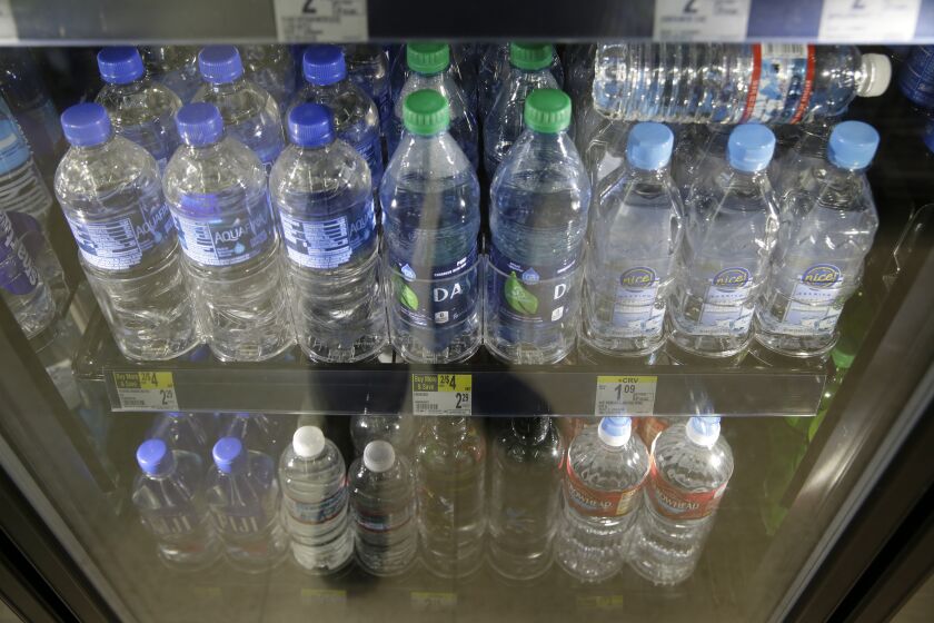 Plastic bottles of water are seen for sale at a store Friday, Aug. 2, 2019, in San Francisco. San Francisco International Airport is banning the sale of single-use plastic water bottles. The unprecedented move at one of the major airports in the country will take effect Aug. 20, the San Francisco Chronicle reported Friday. The new rule will apply to airport restaurants, cafes and vending machines. Travelers who need plain water will have to buy refillable aluminum or glass bottles if they don't bring their own. (AP Photo/Eric Risberg)