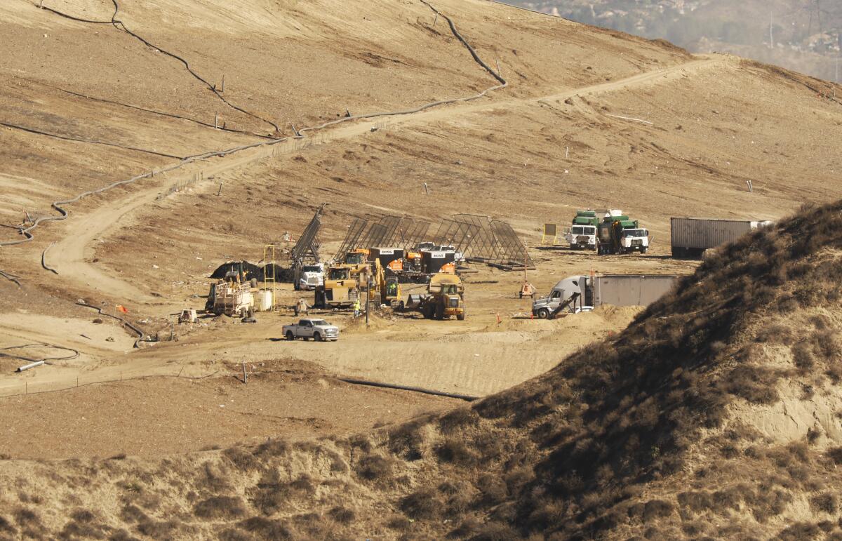 Trucks and heavy machinery in a landfill