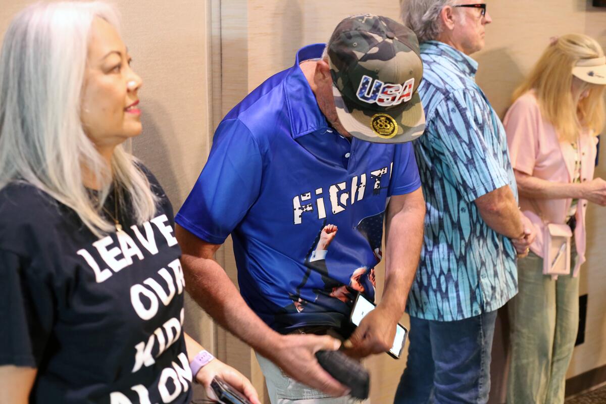 Individuals wait to speak to the Huntington Beach City Council during Tuesday night's meeting.