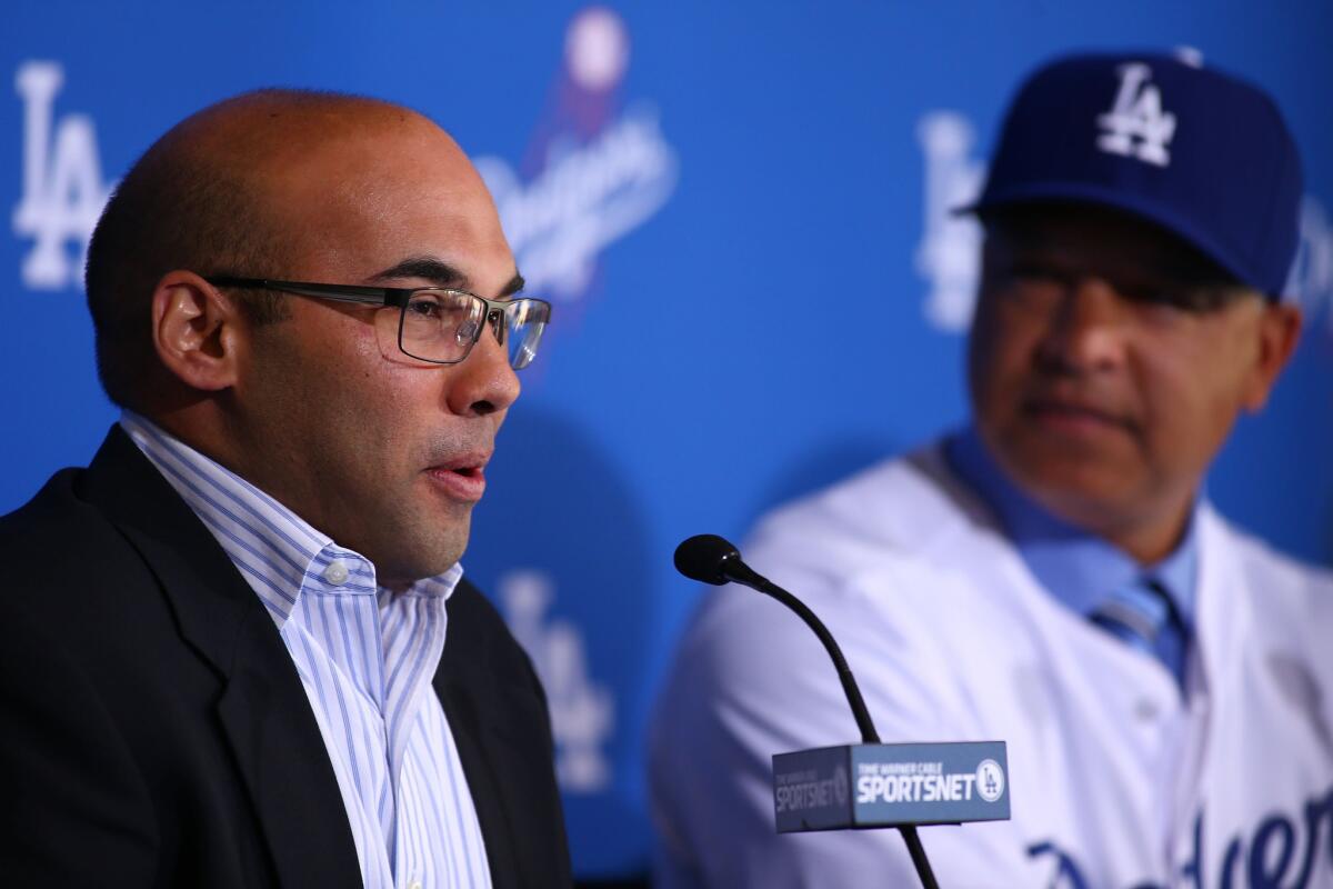 Dodgers General Manager Farhan Zaidi speaks at a news conference introducing new Manager Dave Roberts, right, on Dec. 1.