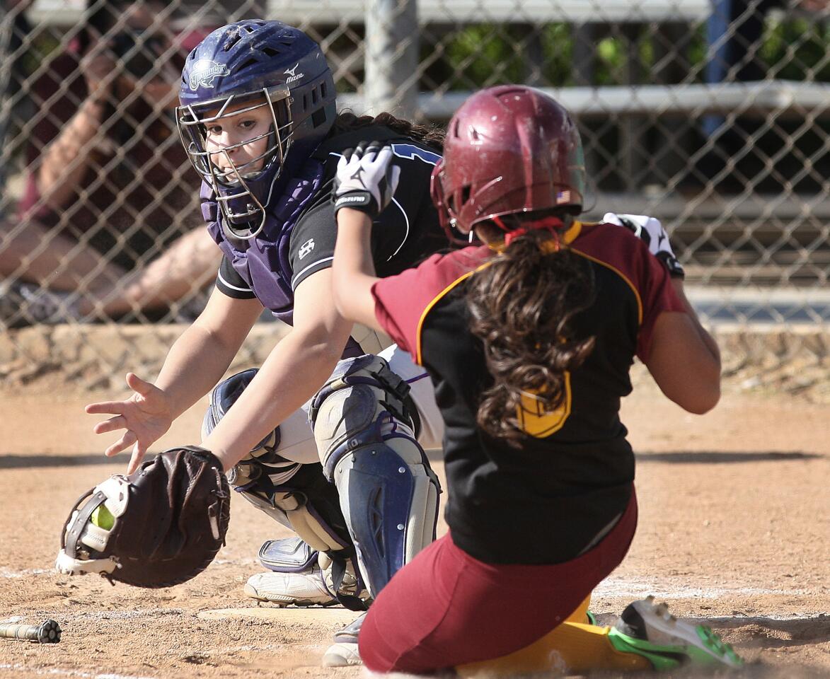 Hoover catcher Jenesy Gonzalez tags Arcadia's Jasmine Rosas out at home during a game at Arcadia High on Thursday, April 3, 2014.