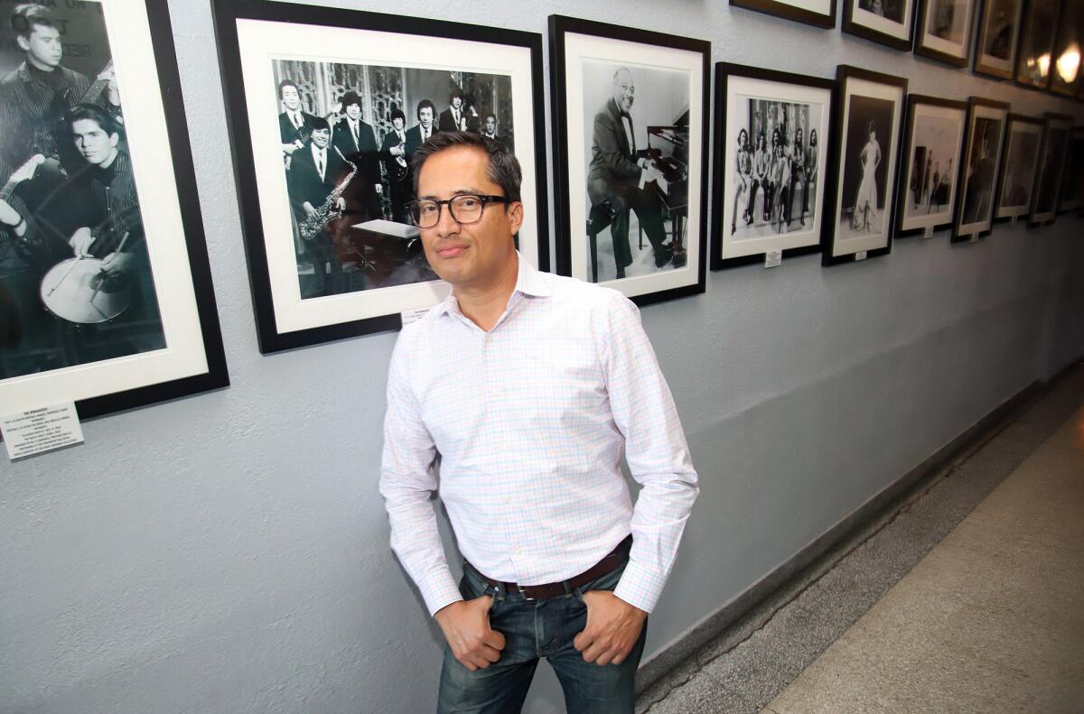 Frank Acevedo, owner of the Paramount Ballroom, in a hallway lined with photographs