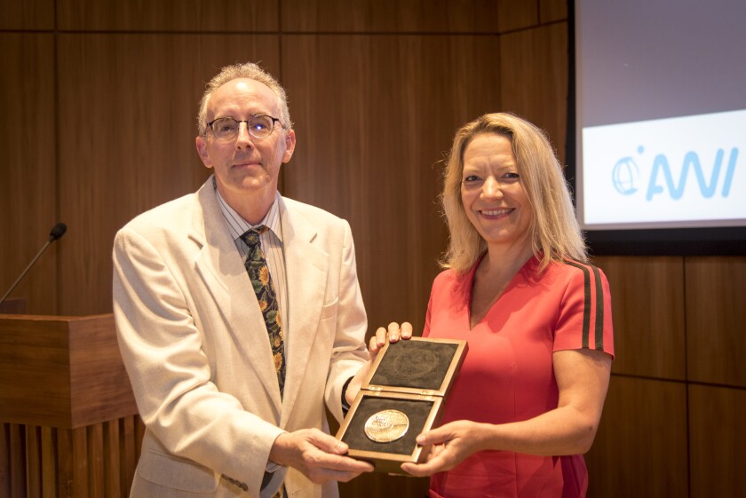 Scripps Oceanography's Doug Bartlett presents the Cody Award to Antje Boetius at Scripps Seaside Forum.