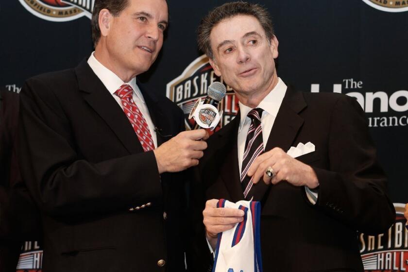 CBS broadcaster Jim Nance talks to Louisville Coach Rick Pitino during the Naismith Memorial Basketball Hall of Fame announcement ceremony.
