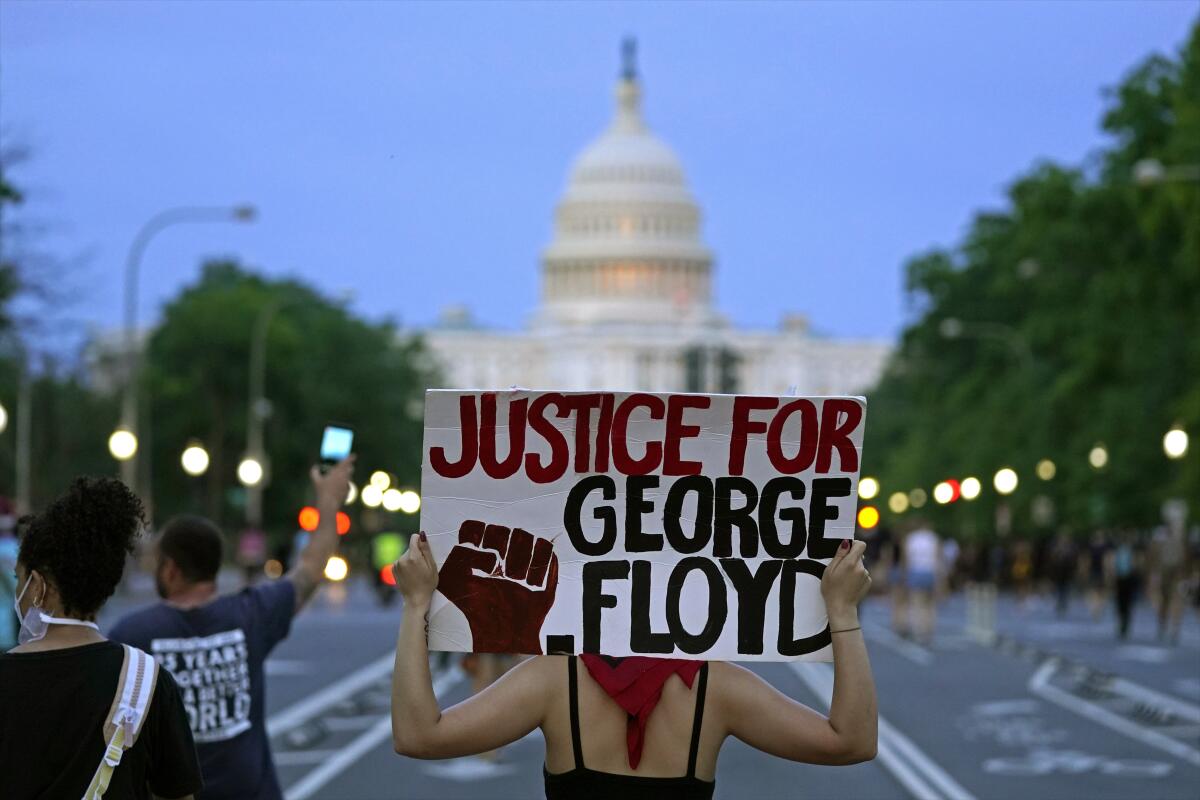 Demonstrators walk along Pennsylvania Avenue in Washington as they protest the death of George Floyd