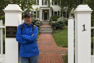 In this photo provided by the Dong family, Dong Yuyu stands at the gates of the Nieman Foundation for Journalism at Harvard University in Cambridge, Mass in May 2017. A veteran Chinese journalist who worked at a ruling Communist Party-affiliated newspaper and was a Harvard University fellow faces espionage charges after he was detained while meeting with a Japanese diplomat in a restaurant, his family said Monday. (Dong Family via AP)