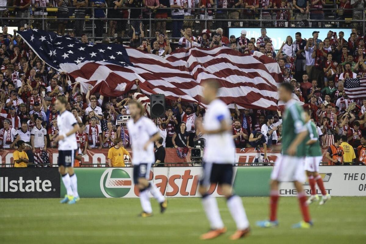 Fans unfurl a large U.S. flag as the U.S. men's soccer team plays Mexico in a friendly on Sept. 10, 2013, in Columbus, Ohio.