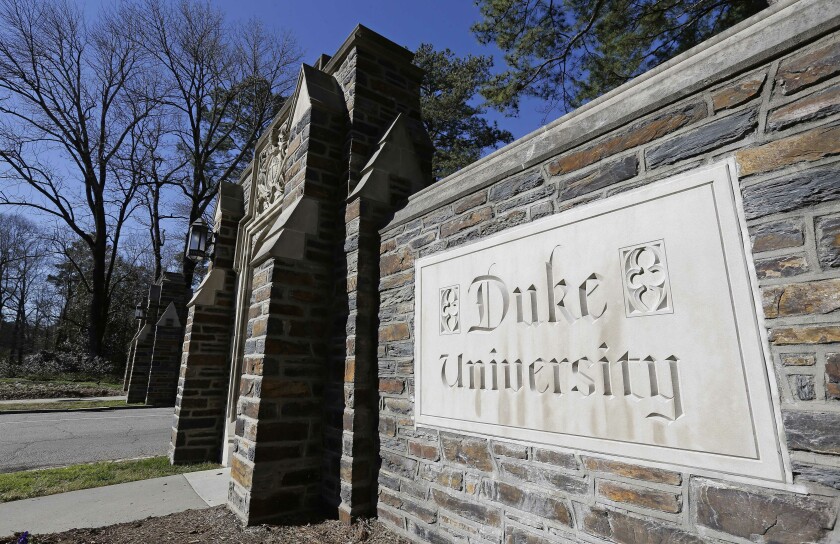 FILE - This Jan. 28, 2019 file photo shows the entrance to the main Duke University campus in Durham, N.C. Duke University announced Wednesday, March 10, 2021, that it is considering ending in-person classes as an uptick in COVID-19 cases over the course of five days worsens and students continue to violate health guidelines. (AP Photo/Gerry Broome, File)
