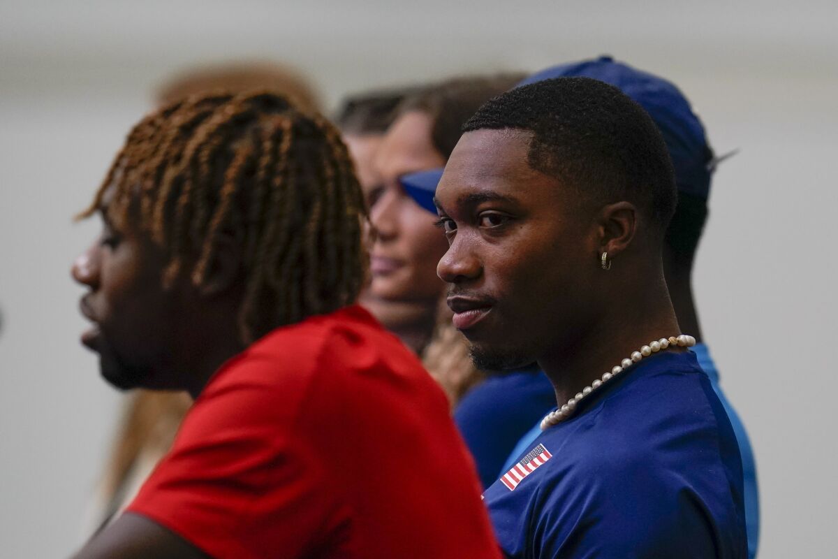 United States' Josephus Lyles listens to his brother, Noah Lyles, as he speaks during a news conference.