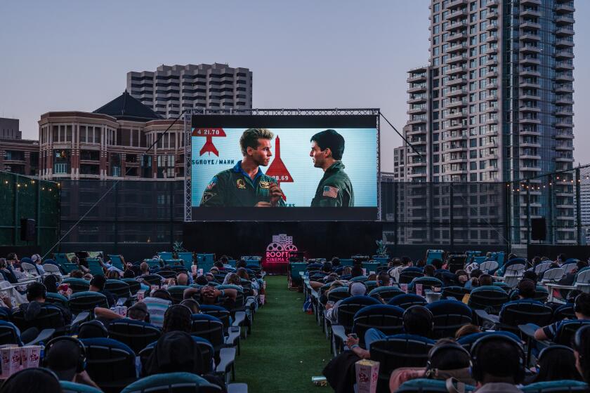 People watchTop Gun at the Rooftop Cinema Club Embarcadero at the Manchester Grand Hyatt in downtown on July 16, 2022.