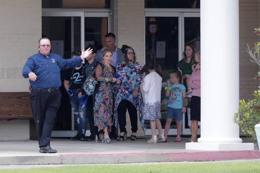 Congregants exit after services at the Life Tabernacle Church in Central, La., Sunday, March 29, 2020.