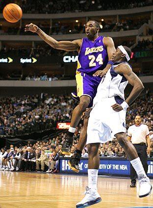 Kobe Bryant passes the ball in front of Dallas' Josh Howard.