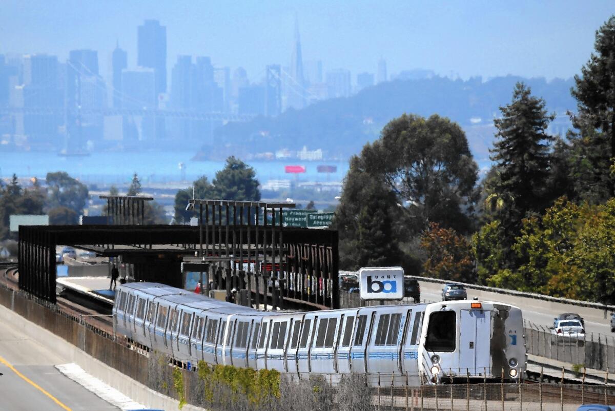 A Bay Area Rapid Transit train pulls away from the Rockridge station in Oakland.