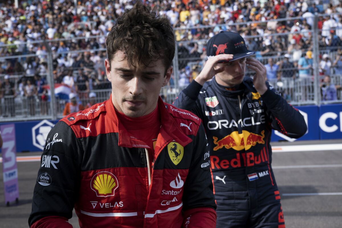 Ferrari driver Charles Leclerc of Monaco walks past Red Bull driver Max Verstappen of the Netherlands after qualifying for the Formula One Miami Grand Prix auto race at Miami International Autodrome, Saturday, May 7, 2022, in Miami Gardens, Fla. Leclerc will start in the pole position and Verstappen in third. (AFP, Brendan Smialowski via Pool)