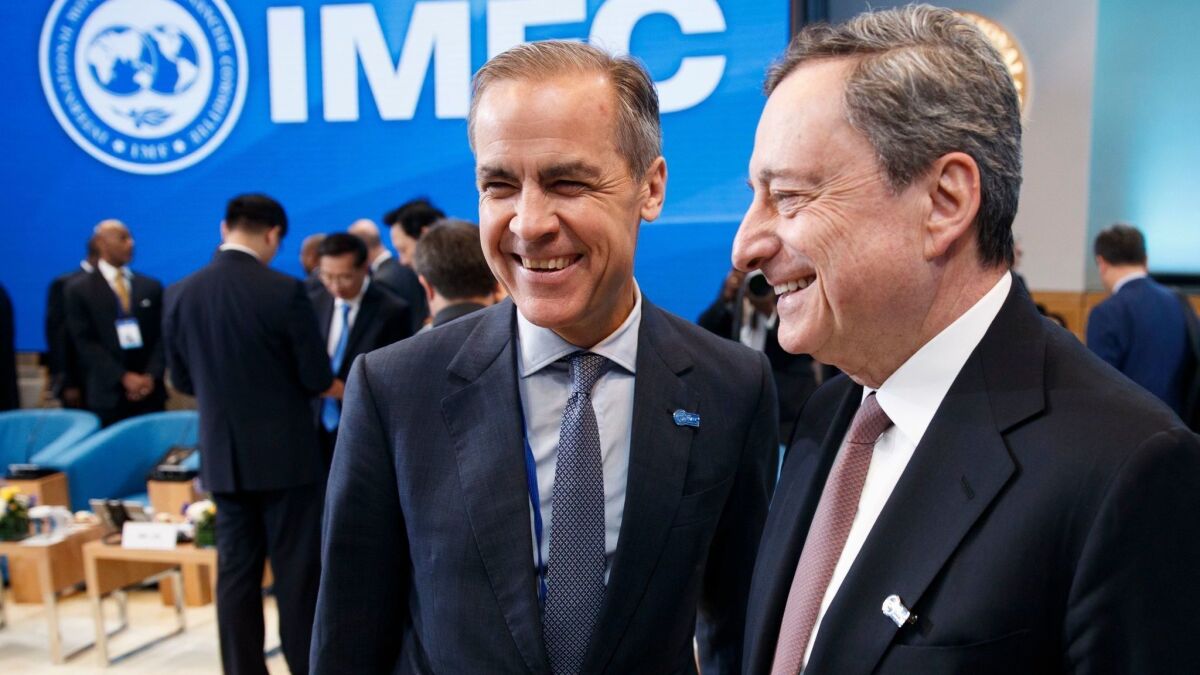 President of the European Central Bank Mario Draghi, right, with Governor of the Bank of England Mark Carney.