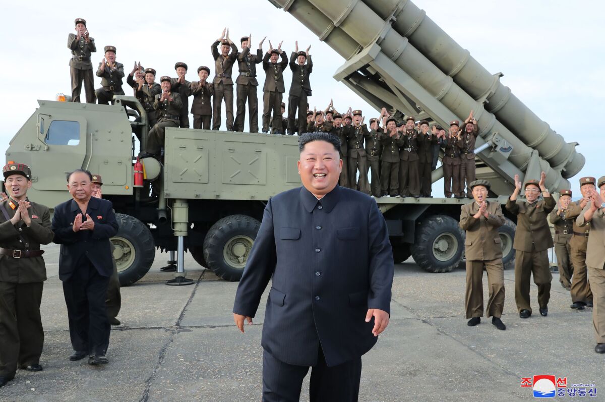 This Saturday, Aug. 24, 2019, photo provided Sunday, Aug. 25, by the North Korean government, shows North Korean leader Kim Jong Un, center, smiles after the test firing of an unspecified missile at an undisclosed location in North Korea. North Korea fired two suspected short-range ballistic missiles off its east coast on Saturday in the seventh weapons launch in a month, South Korea's military said, a day after it vowed to remain America's biggest threat in protest of U.S.-led sanctions on the country. The content of this image is as provided and cannot be independently verified. Korean language watermark on image as provided by source reads: "KCNA" which is the abbreviation for Korean Central News Agency. (Korean Central News Agency/Korea News Service via AP)