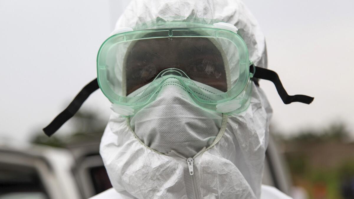 A Liberian nurse wears protective clothing while working with an Ebola virus victim on the outskirts of Monrovia, Liberia, on Wednesday.