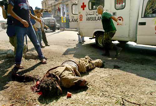 Nazzi Ali Mutkak, who locals say ran a coffee stand, was killed in a direct hit on one of the main streets of Tyre, Lebanon. Civil defense arrived to take him to the hospital, but he died on the way. Two small coffee cups fell by his side. Israelis killed at least three people in Tyre on Sunday, in several direct attacks.