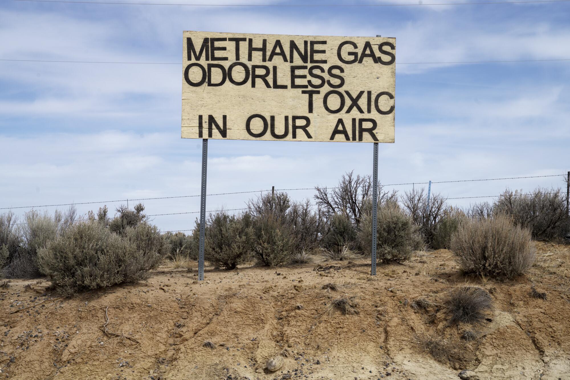 a sign reads methane gas odorless toxic in our air