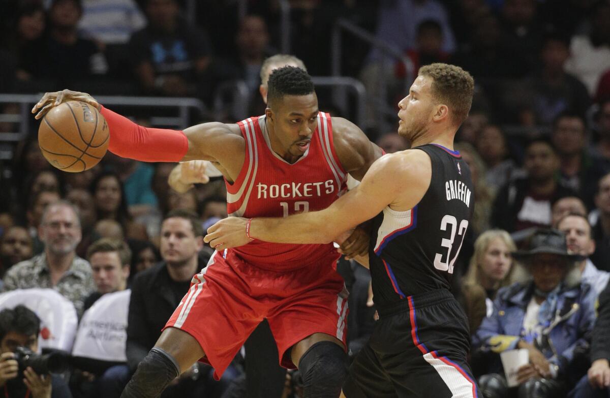 Houston Rockets center Dwight Howard tries to back down Clippers forward Blake Griffin during the first half of a game Nov. 7 at Staples Center.