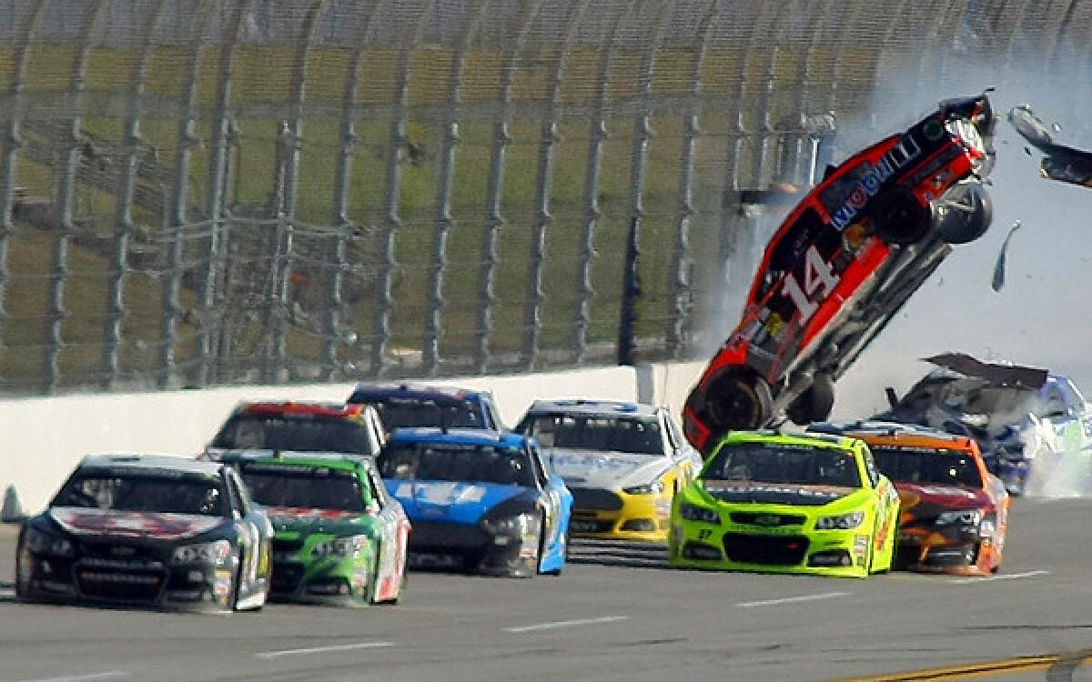 The car of Sprint Cup Series driver Austin Dillon (14) goes airborne with Jamie McMurray (1) in the lead on the last lap Sunday at Talladega Superspeedway.