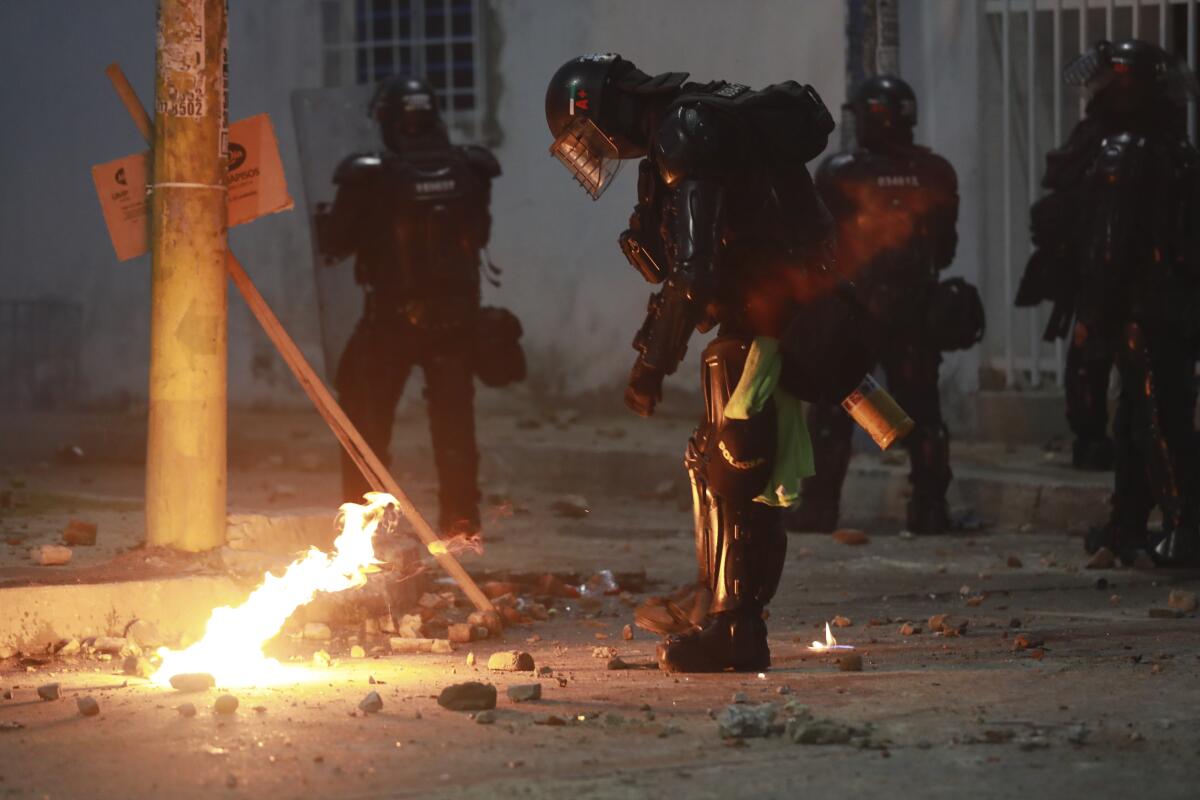 Riot police putting out petrol bomb