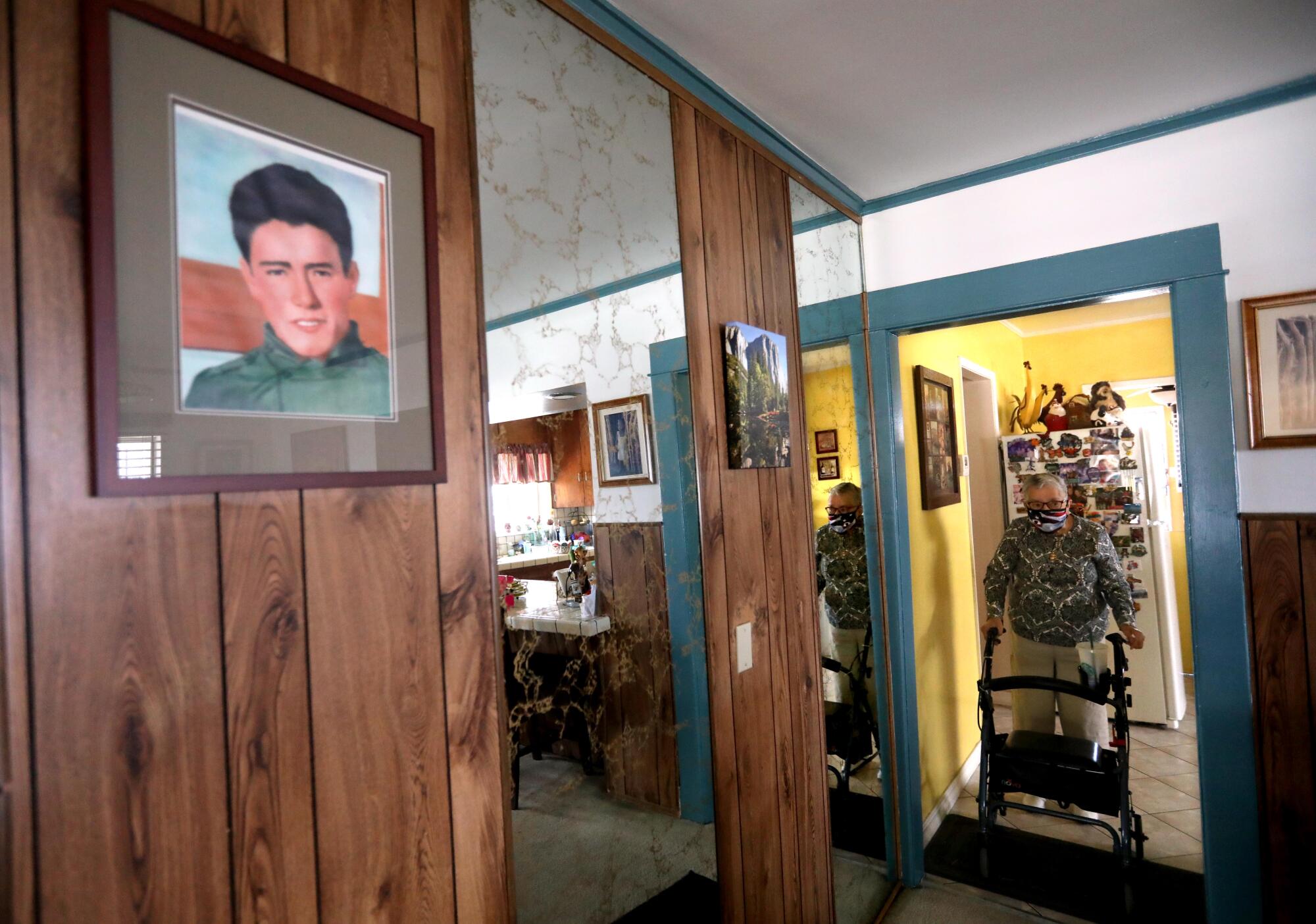 Ruth Soto stands in her home, with a photo of Jacob Cruz on a wall