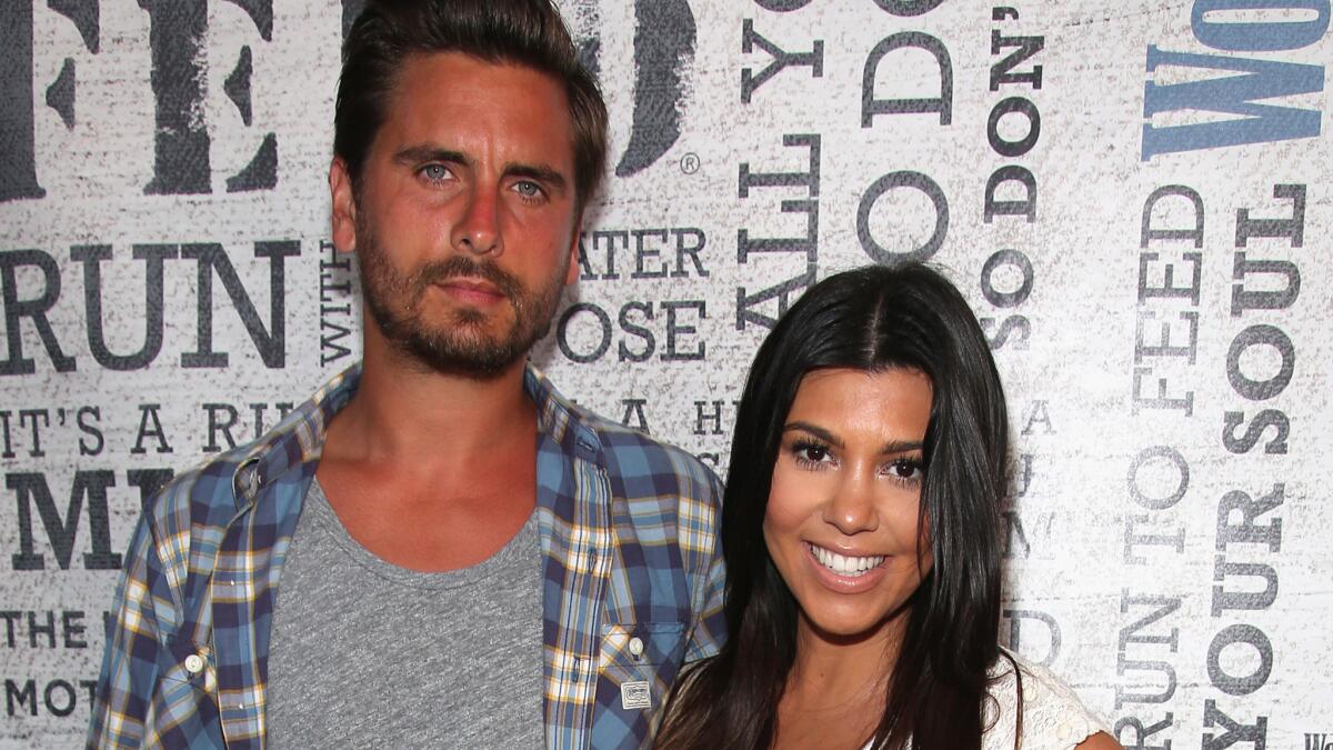 Scott Disick and Kourtney Kardashian at a party in the Hamptons in August 2014.