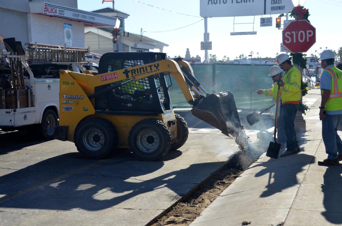 Balboa Island underground utility crew fill trenches on Agate Avenue on Tuesday. 