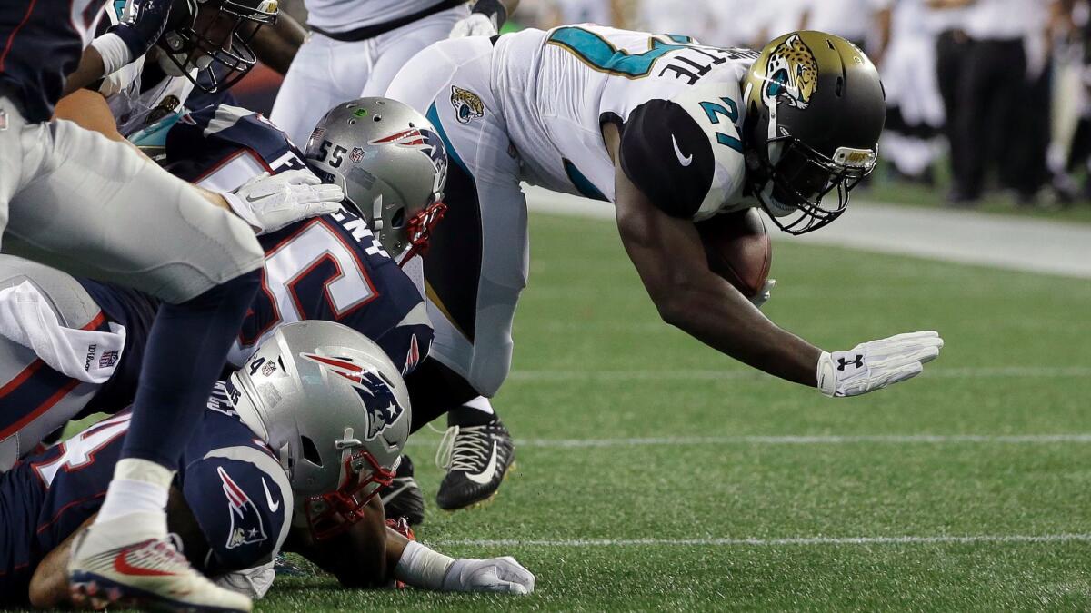 Jacksonville Jaguars running back Leonard Fournette dives for yardage against the New England Patriots during an exhibition game on Aug. 10.