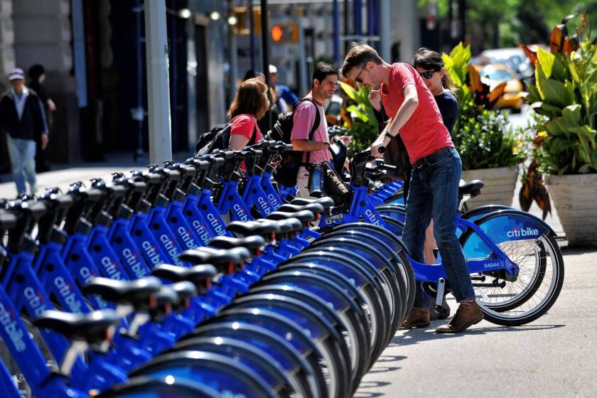A couple pick out bicycles to rent from the CitiBike bike sharing program in New York. Citibank is a sponsor of the program, which launched last month.