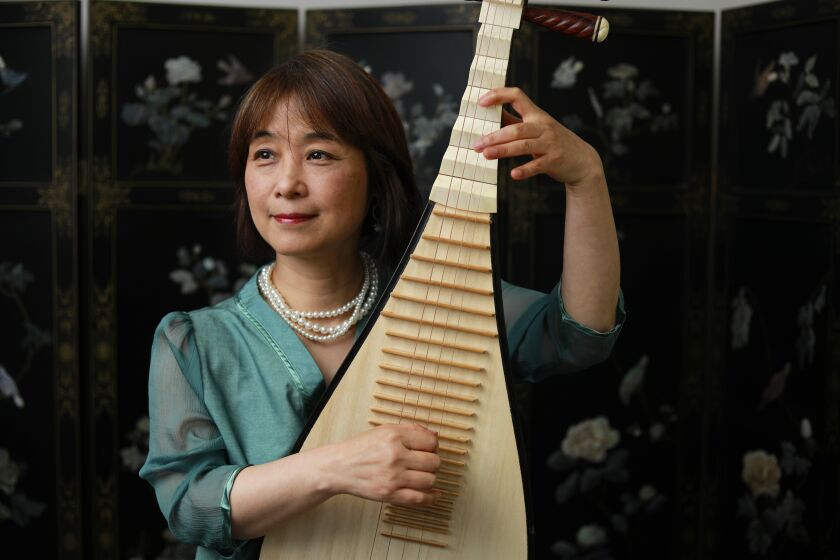 CARLSBAD, CA - MAY 27: Wu Man is a pipa virtuoso, shown in her home on Thursday, May 27, 2021 in Carlsbad, CA. . (K.C. Alfred / The San Diego Union-Tribune)