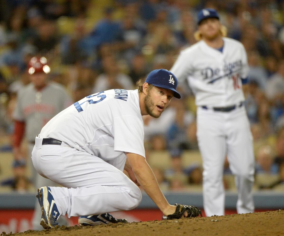 Clayton Kershaw watches Justin Turner (not pictured) throw out Billy Hamilton to end the Reds' fifth inning Wednesday at Dodger Stadium.