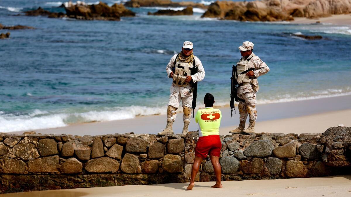 Mexican soldiers in August patrol Palmilla Beach, where three men were killed by a group with automatic weapons in San Jose del Cabo, Baja California Sur.