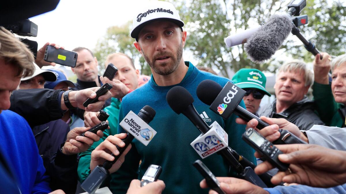 Dustin Johnson speaks with reporters April 6 after withdrawing from the Masters because of an injury.