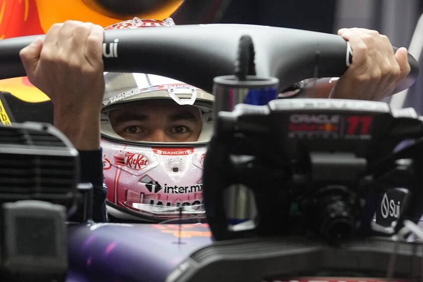 Red Bull driver Sergio Perez, of Mexico, gets into his car during the final practice session for the Formula One Las Vegas Grand Prix auto race, Friday, Nov. 17, 2023, in Las Vegas. (AP Photo/Darron Cummings)