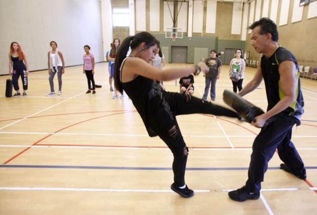 Alexandria Meneses, of Burbank, learns self defense techniques from instructor Nelson Nio at Pacific Community Center in Glendale on Tuesday.
