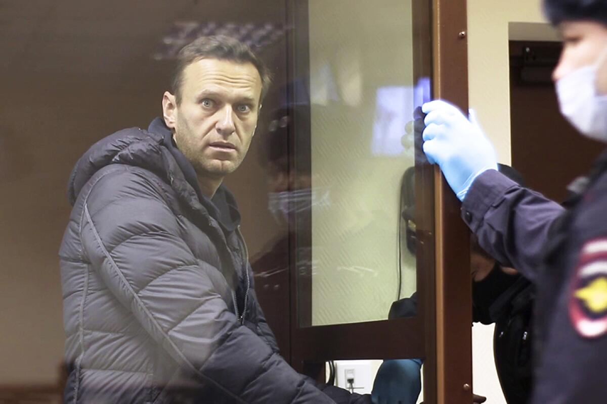 Alexei Navalny wears a coat in court.