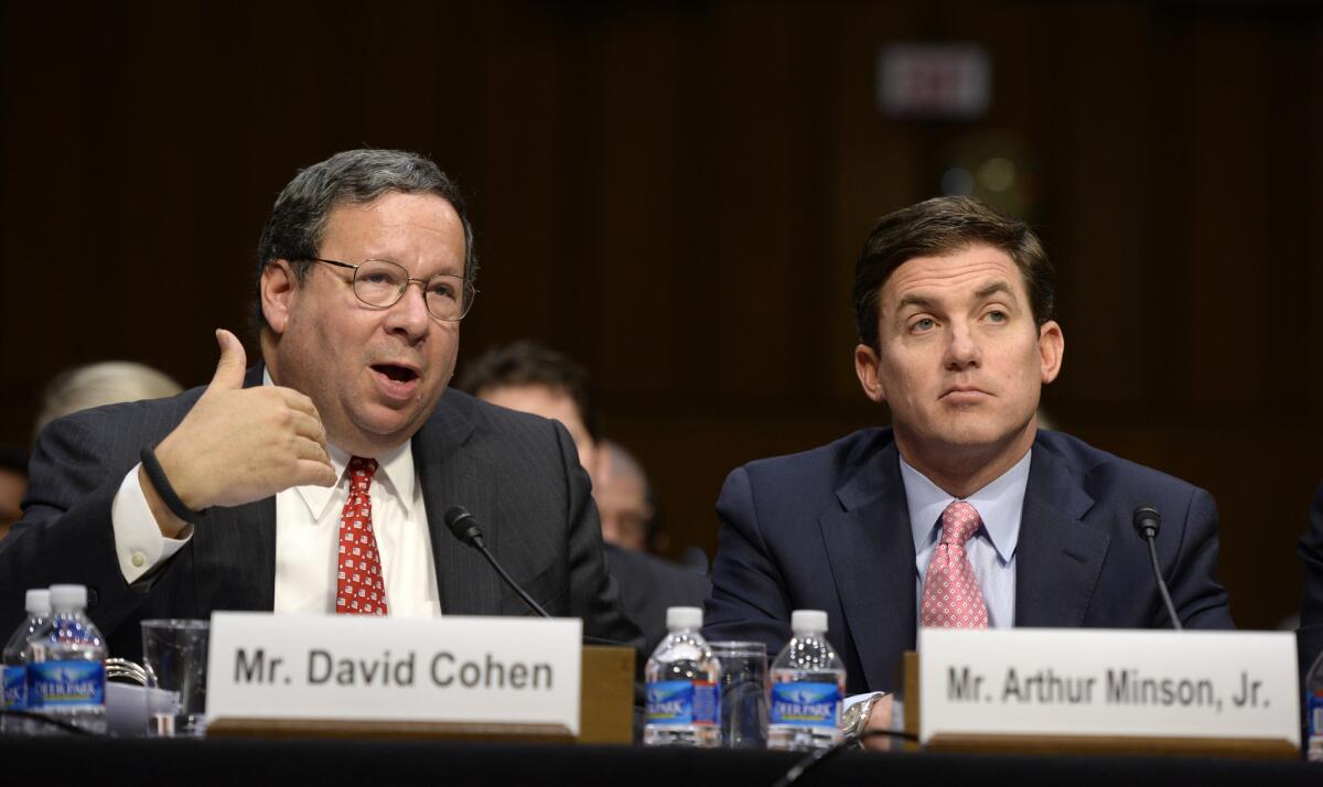 Comcast Executive Vice President David Cohen, left, and Time Warner Cable Chief Financial Officer Arthur T. Minson, Jr., tell a Senate committee why their merger will be good for your viewing health.