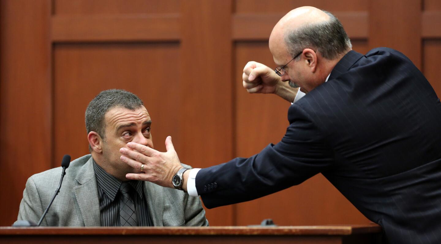 Prosecutor Bernie de la Rionda demonstrates a possible scenario while questioning state witness Chris Serino, a Sanford police officer, during the George Zimmerman trial in Seminole circuit court, in Sanford, Fla., Tuesday, July 2, 2013. Zimmerman is charged with 2nd-degree murder in the fatal shooting of Trayvon Martin, an unarmed teen, in 2012. (Joe Burbank/Orlando Sentinel/POOL) newsgate CCI B583034032Z.1